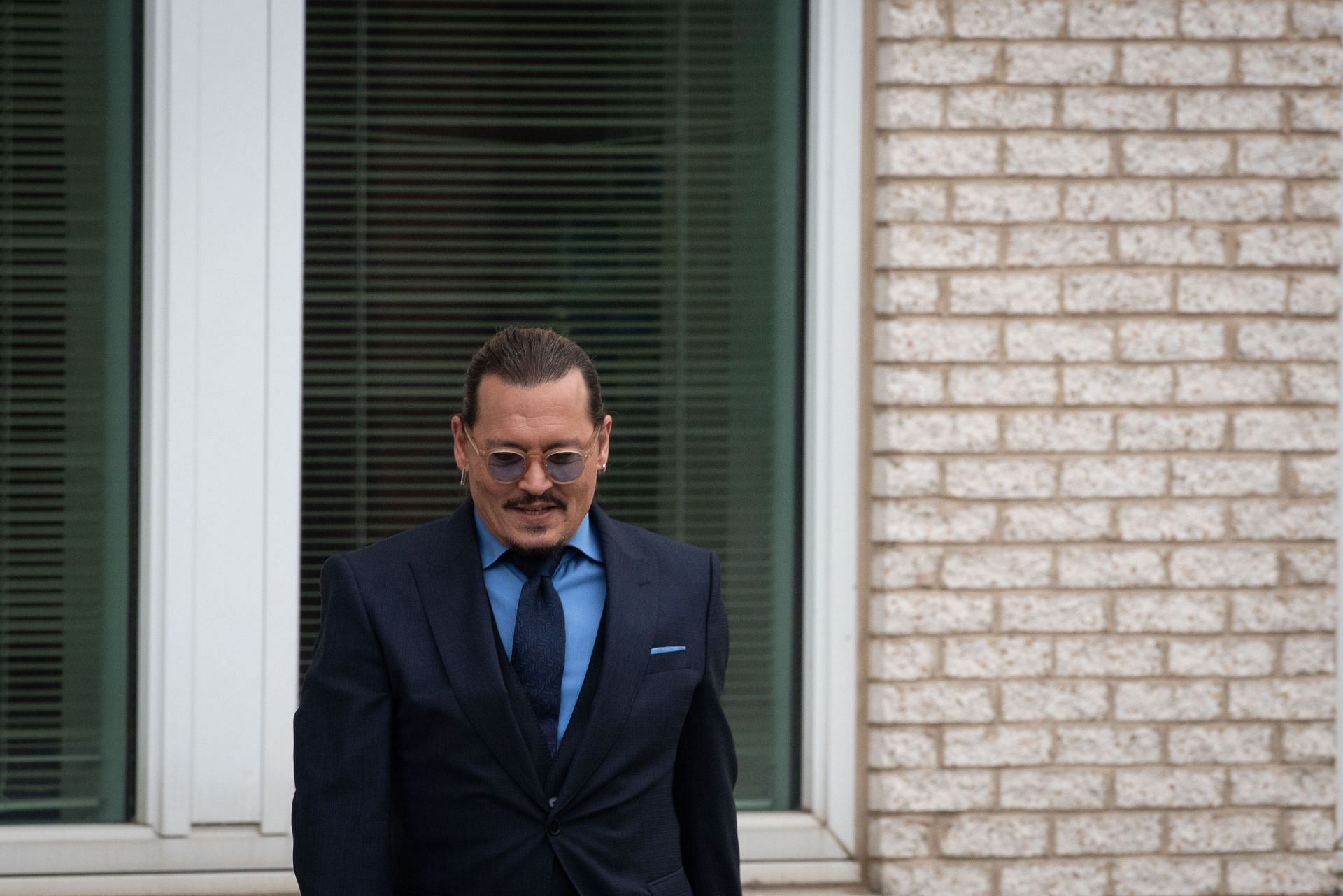 Johnny Depp departs outside court during the trial at Fairfax County Circuit Court on May 27, 2022. (Image via Getty)